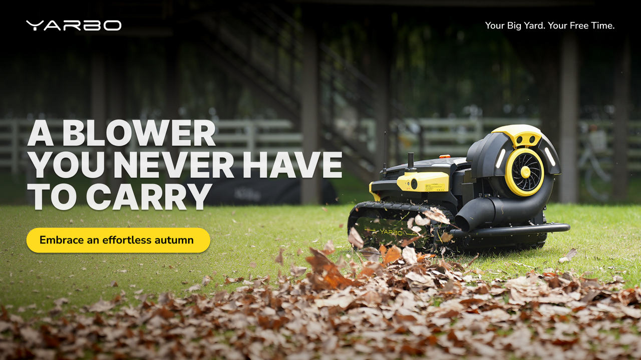 Yellow and black robotic leaf blower on grass, blowing autumn leaves, effortless yard cleanup.
