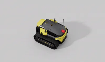 Yellow and black tracked robot with red button and antenna on gray surface.
