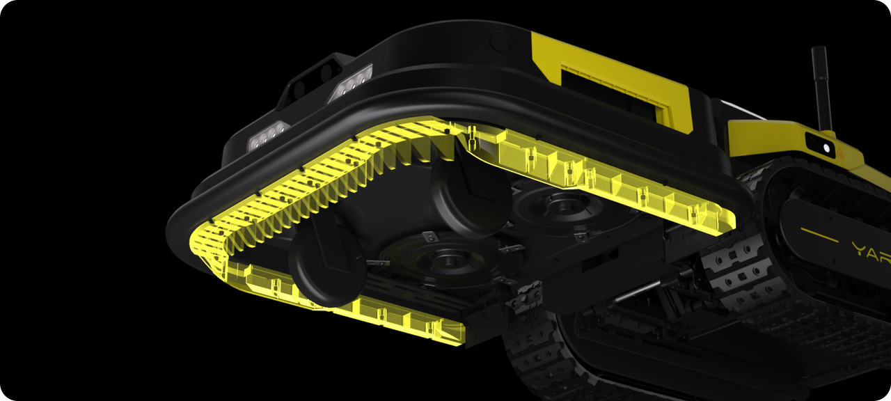 Black and yellow robotic lawn mower with transparent deck revealing internal blades and drive system, track wheels, and front lights.