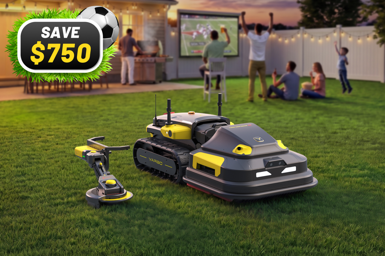 Gray and yellow robotic lawn mowers on green grass with family watching football on large screen in background. Save $750.
