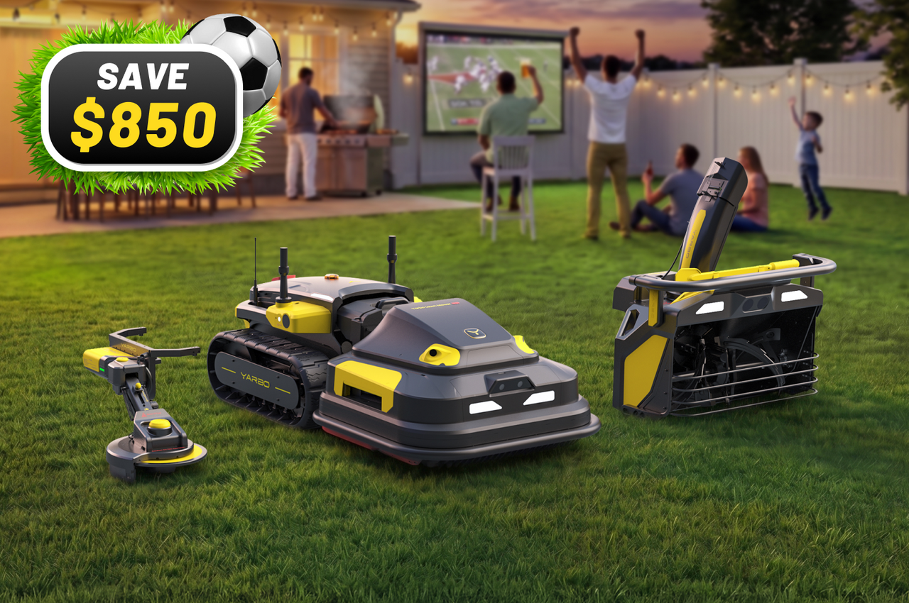 Four gray and yellow robotic lawn mowers on green grass with people watching a game on a screen in the background; "SAVE $850" text in top left.