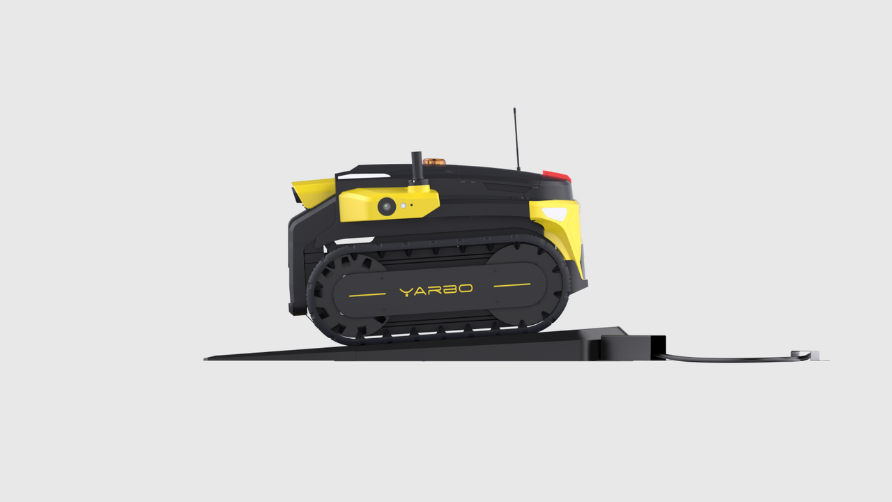 Black and yellow Yarbo robot with tank treads docked on charging station, showcasing smart wireless charging technology.
