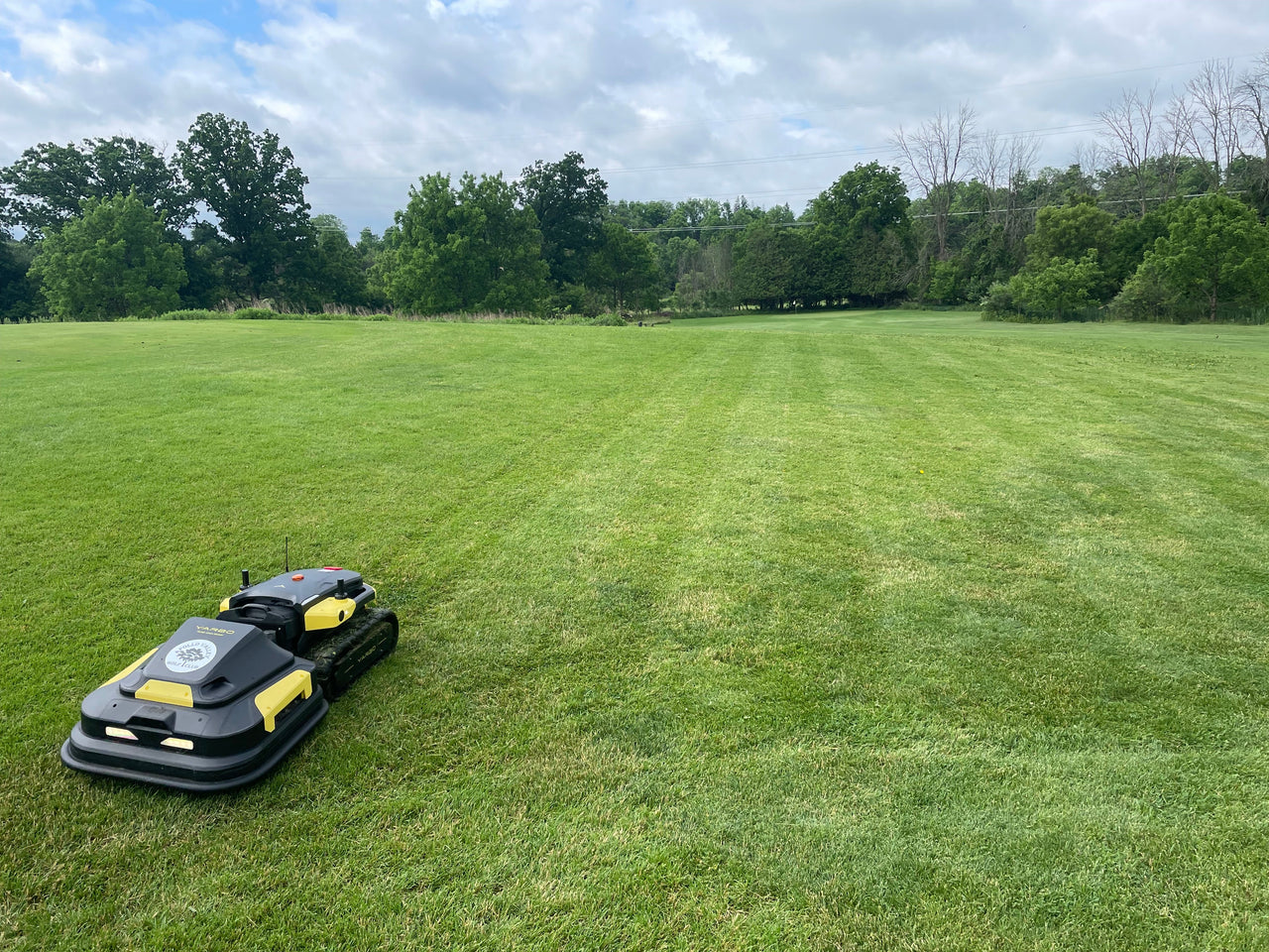 Yarbo robotic mower on lush green lawn, ready for precision cutting on high-end properties.