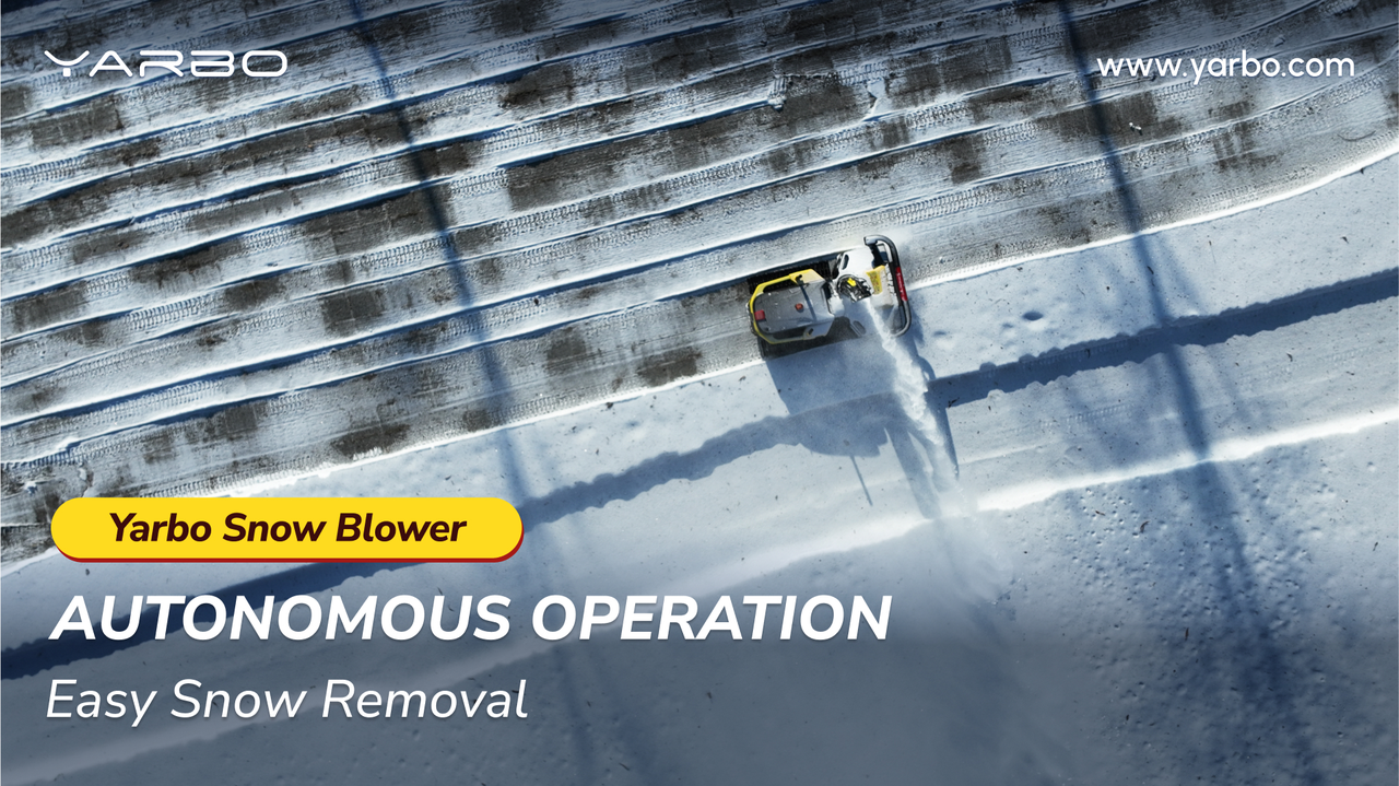 Yellow Yarbo autonomous snow blower clearing driveway, leaving clean path in bright winter sun.