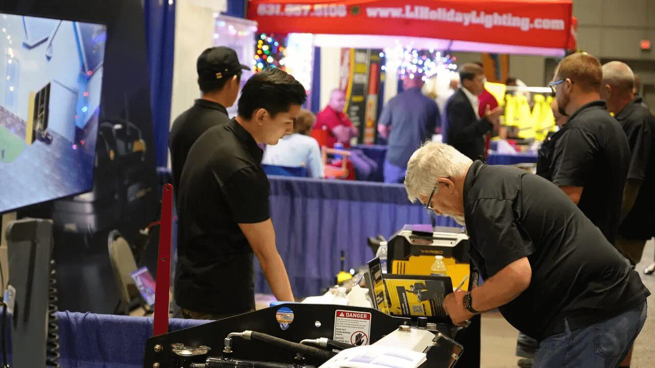 Yarbo booth at SIMA 2023: attendees examine equipment, engage with staff, and explore products in a vibrant trade show setting.