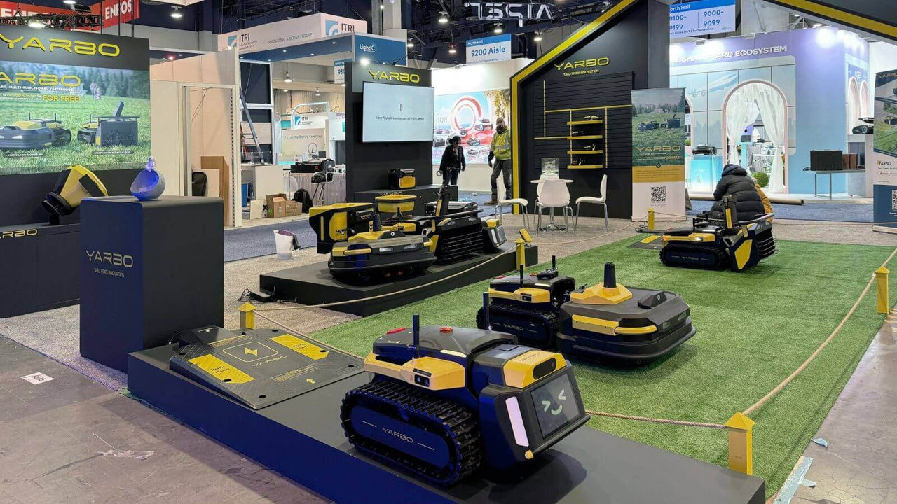 Yarbo's sleek black and yellow robotic lawn mowers on display at CES 2024, showcasing smart yard care innovation.