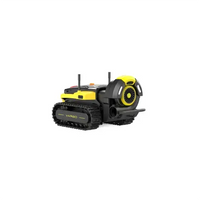 Yellow and black YARDO robotic lawn mower with tank tracks and side discharge, isolated on white.