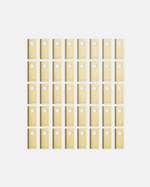 40-piece set of beige YARBO cutting blades with circular holes, arranged in grid, Y Series design, flat lay view