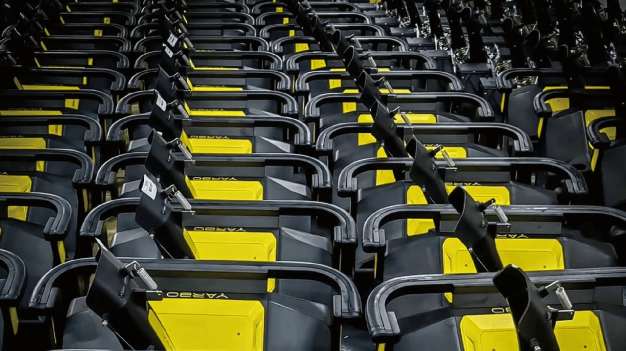 Rows of black and yellow YARBO stadium seats with armrests and cup holders, arranged in a repeating pattern.