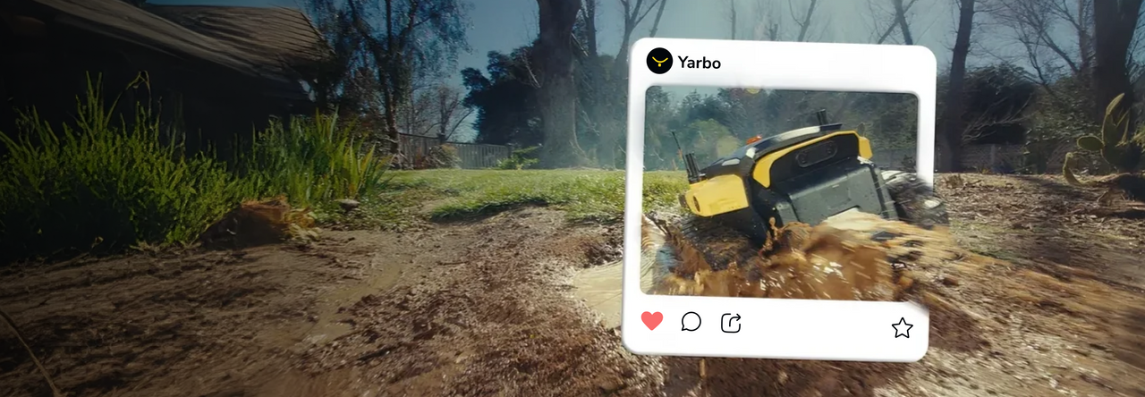 Yellow and black armored vehicle splashes through mud in a rural setting, overlaid with a social media post from "Yarbo" featuring interaction icons.
