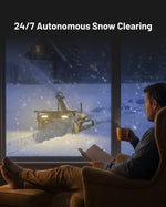 Yellow and black snow blower module (Y Series) in action clearing snow at night, viewed from inside through a window, with illuminated headlights and snow spray.