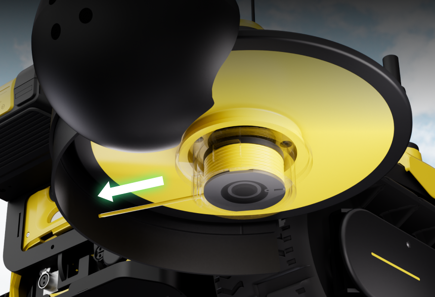 Close-up of yellow and black robotic arm with transparent gear housing, green arrow indicating leftward motion, against cloudy sky background.