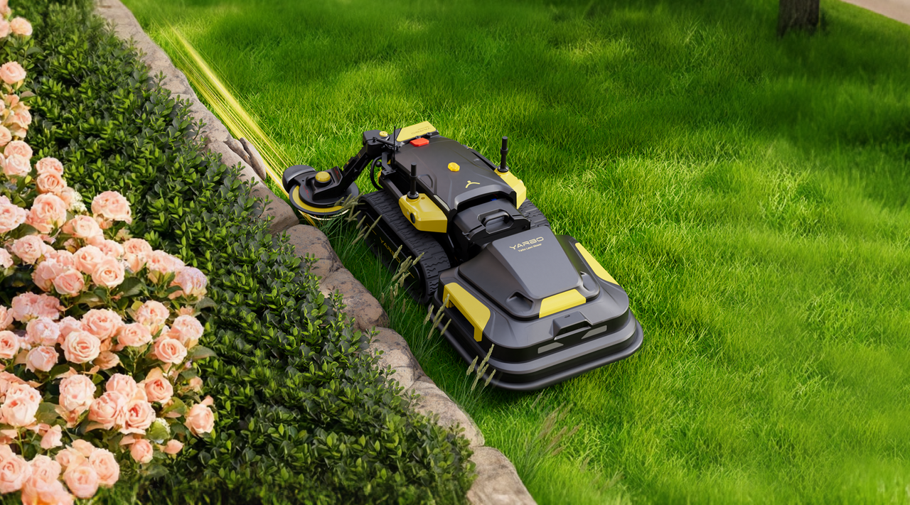 Black and yellow YARBO robotic lawn mower trimming grass beside pink roses and green shrubs.