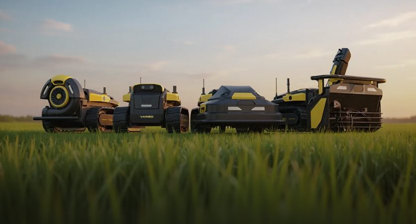 Four black and yellow agricultural robots in a green field at sunset, with "YARBO" visible on one unit.