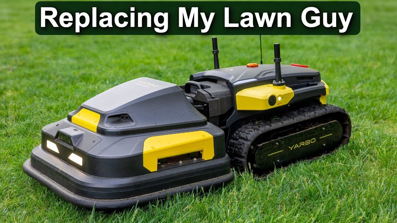 Two black and yellow robotic lawn mowers on green grass, labeled "YARBO," under text "Replacing My Lawn Guy."